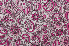 Load image into Gallery viewer, This cute and soft cotton paisley print bandana with floral accents in shades of pink outline in black against white background. 
