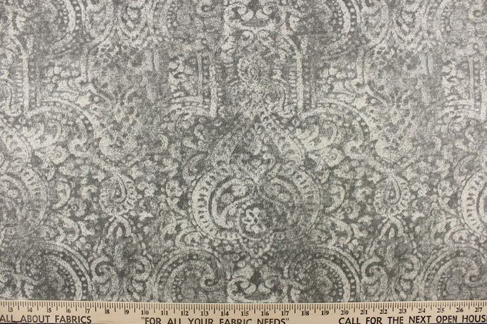 This beautiful fabric features a demask design in a  gray with hints of off white. 