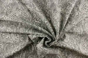 This beautiful fabric features a demask design in a  gray with hints of off white. 