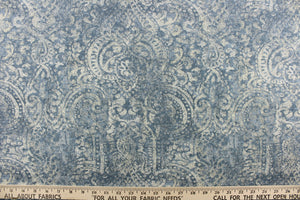 This beautiful fabric features a demask design in a Windsor blue  with hints of off white. 