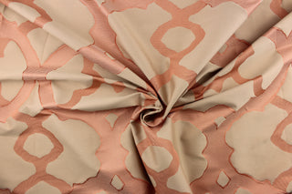 This light weight Jacquard fabric features a geometric scroll design on a silken background in tones of Coral. 