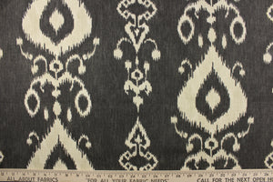 This fabric features an ikat design in a charcoal gray and off white. 