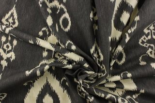 This fabric features an ikat design in a charcoal gray and off white. 