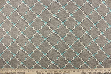 Load image into Gallery viewer, This fabric features a geometric design in white, off white and pale teal blue outlined in black against a gray background. 
