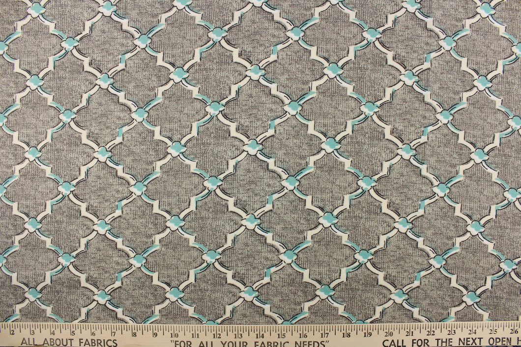 This fabric features a geometric design in white, off white and pale teal blue outlined in black against a gray background. 