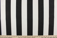 Load image into Gallery viewer, This outdoor fabric features a wide stripe design in white and black. 
