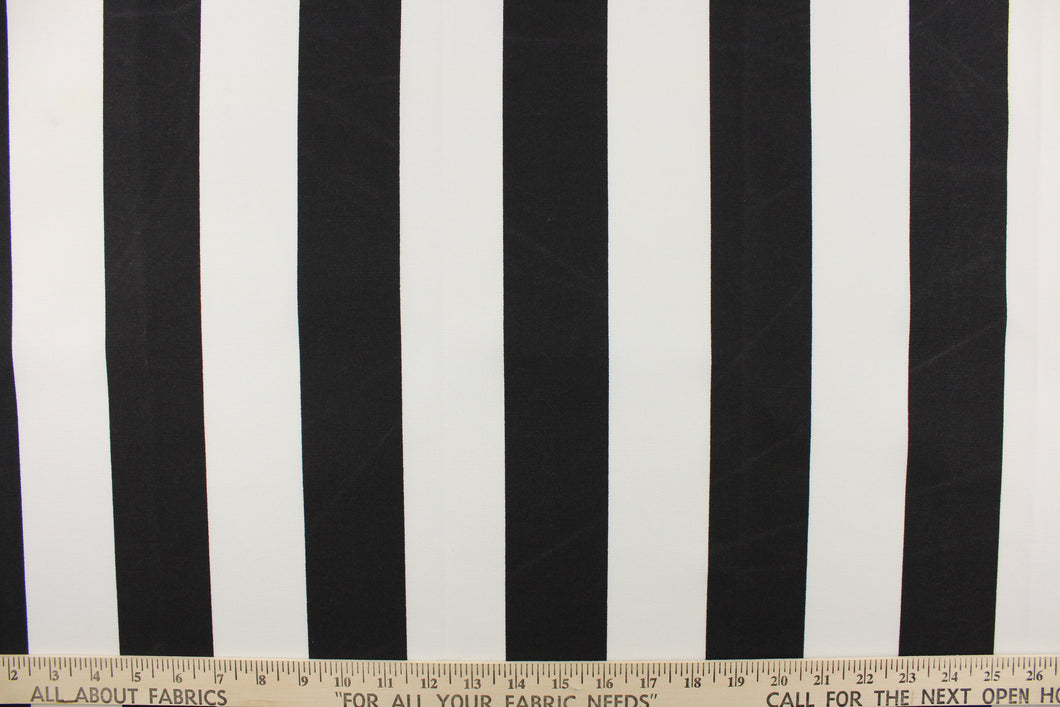 This outdoor fabric features a wide stripe design in white and black. 