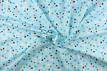Load image into Gallery viewer, This cute quilting print features a white dog with black ears and different colored collars mix in with blue paw prints on a pale blue background. 
