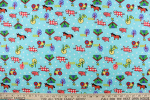 This Old MacDonald cotton print fabric features farm animals, tractors and trees in red, white, green, blue, black, yellow and pink against an aqua blue background.