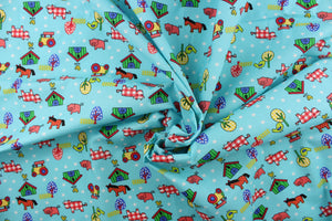 This Old MacDonald cotton print fabric features farm animals, tractors and trees in red, white, green, blue, black, yellow and pink against an aqua blue background.