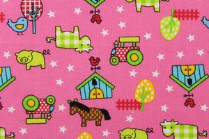  This Old MacDonald cotton print fabric features farm animals, tractors and trees in red, white, lime green, blue, black, and yellow against an pink background