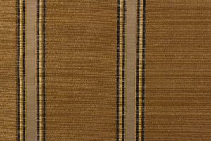 This rich woven yarn dyed fabric features bold striped pattern in shades of dark brown and gold against an old gold.
