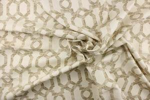  This fabric features geometric design in taupe or brown gray tones against a white background. 