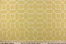 Load image into Gallery viewer, This embroidered fabric features a geometric design in white against a mustard yellow.
