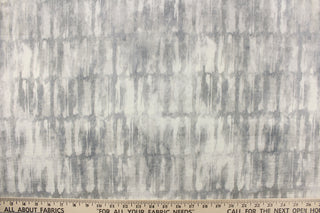 This fabric features an abstract design in shades of gray and off white.