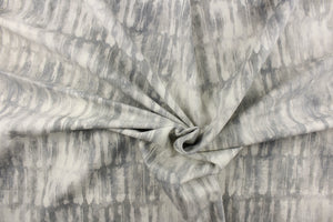 This fabric features an abstract design in shades of gray and off white.