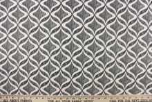 Load image into Gallery viewer, This fabric features a geometric design in white on against a thin black stripes.
