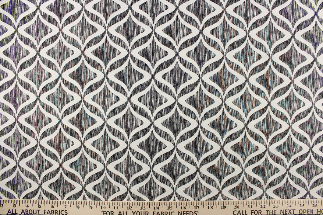 This fabric features a geometric design in white on against a thin black stripes.