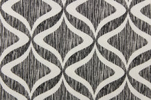 Load image into Gallery viewer, This fabric features a geometric design in white on against a thin black stripes.
