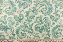 Load image into Gallery viewer, This beautiful fabric features a whimsical floral design in teal green with a beige outline against a creamy white background. 
