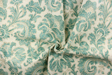 Load image into Gallery viewer, This beautiful fabric features a whimsical floral design in teal green with a beige outline against a creamy white background. 

