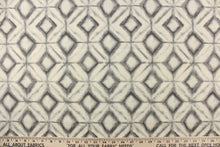Load image into Gallery viewer, This fabric features a geometric design of diamonds in varying shades of gray against a off white. 
