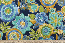 Load image into Gallery viewer, This outdoor fabric features a floral design in varying shades of blue, green, teal, pale yellow, and a dark mustard tone with hints of black and white on a navy blue background.
