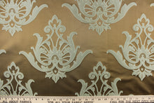 Load image into Gallery viewer, This lightweight Jacquard fabric features a woven damask design on a silken background. The colors included are brown/taupe and teal.
