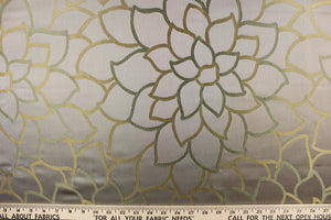 This elegant jacquard fabric features a woven floral design in a green and beige against a taupe brown.
