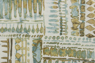 This fabric features an abstract design in blue green tones with tan and brown shades against a off white background. 