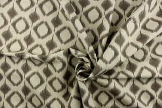This fabric features a geometric design in diamond shapes in a brown tone against a gray brown background. 