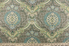 Load image into Gallery viewer, This unique fabric feature a medallion in varying shades of green, and  blue, with hints cream, gold and khaki against a taupe cheetah print. 
