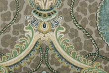 Load image into Gallery viewer, This unique fabric feature a medallion in varying shades of green, and  blue, with hints cream, gold and khaki against a taupe cheetah print. 
