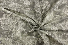 Load image into Gallery viewer, This fabric features a whimsical floral design in a off white against a gray with green undertones.
