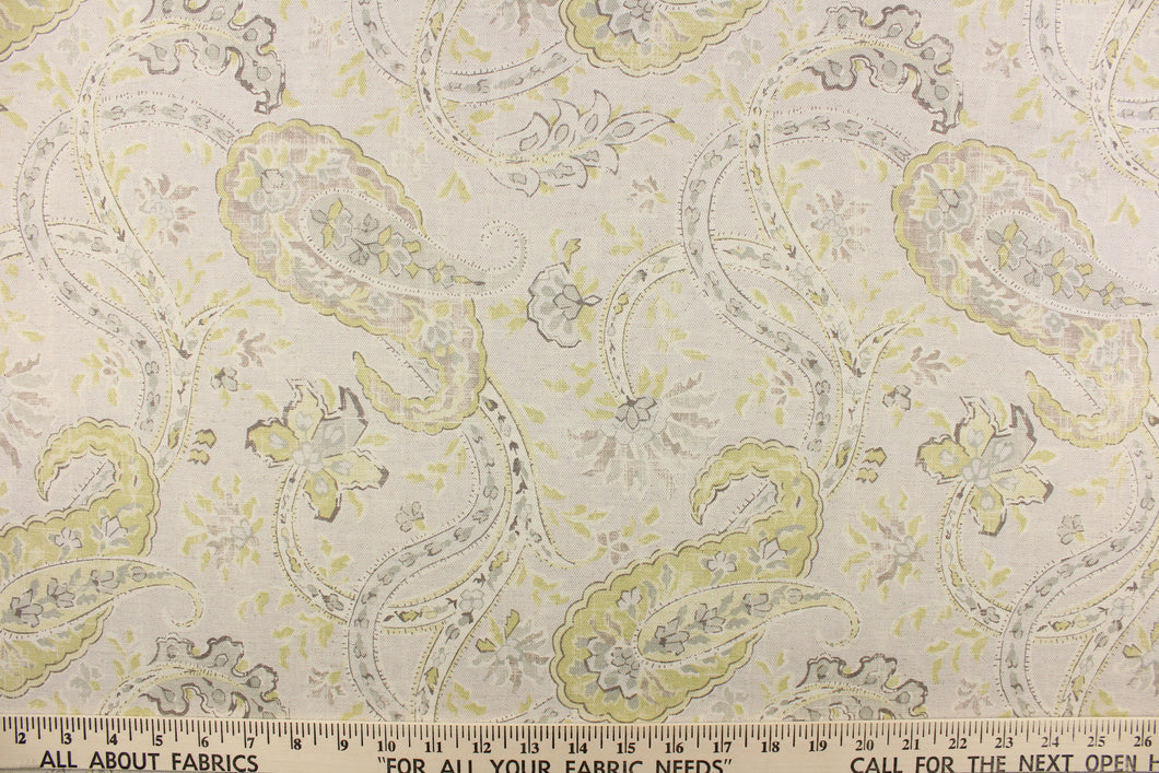 This fabric features a paisley vine design in a pale lime green and gray on a natural background. 