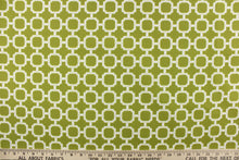 Load image into Gallery viewer, This outdoor fabric features a geometric design in white against a pear green background.
