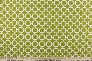 This outdoor fabric features a geometric design in white against a pear green background.