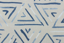 Load image into Gallery viewer,  This fabric features a geometric design of triangles in a blue jean blue color with hints of white against gray.
