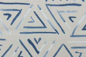  This fabric features a geometric design of triangles in a blue jean blue color with hints of white against gray.