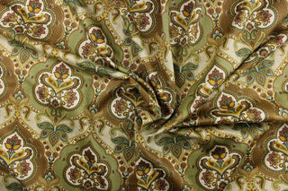 This silky fabric features a damask pattern with a paisley print design set on a light brown background.  It can be used for apparel, bedding, drapery, accent pillows.  Colors included are green, gold, brown and dark red.