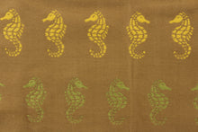 Load image into Gallery viewer, This indoor/outdoor beachy fabric features seahorses on a khaki background with a soil and stain resistant finish.  It is repellent of water and mildew.  Durable with 1,500 hours light fastness and exceeds 50,000 double rubs.  Use this for multi purpose upholstery, bedding, accent pillows and drapery.  Colors included are yellow, teal and green.
