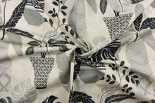 Load image into Gallery viewer, This fabric features a floral design of flowers in pots in varying shades of gray, black, and white against an off white or natural background.
