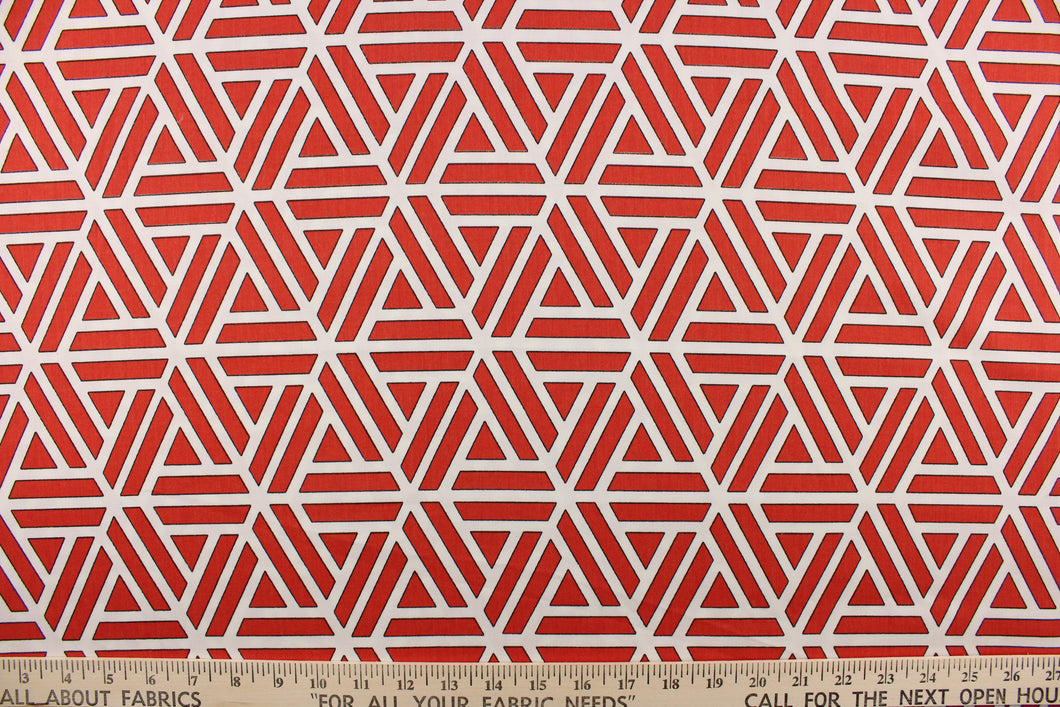 This fabric features a geometric abstract design in white, and red with black outline. 