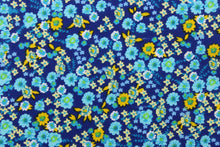 Load image into Gallery viewer, This quilting print features a beautiful floral design in varying shades of blue, yellow and white against a royal blue background
