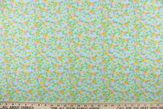 This soft quilting print features a beautiful floral design in pink, yellow, green and blue against a light blue background.