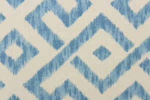  This fabric features a geometric design in blue and natural or off white