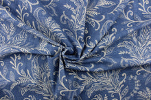 Load image into Gallery viewer, This fabric features a floral design in off white against a denim blue background.
