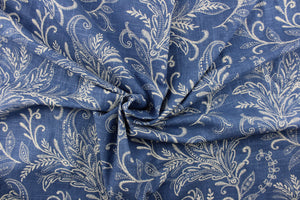 This fabric features a floral design in off white against a denim blue background.