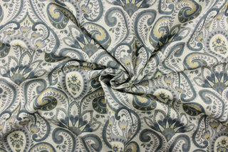 This fabric features a demask paisley design in shades of gray, green tones, hints of blue tones, and a pale gold against an off white or cream background. 
