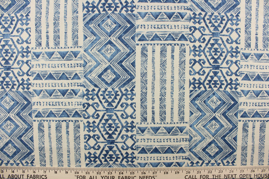  This fabric features a geometric design in blue and natural or off white. 